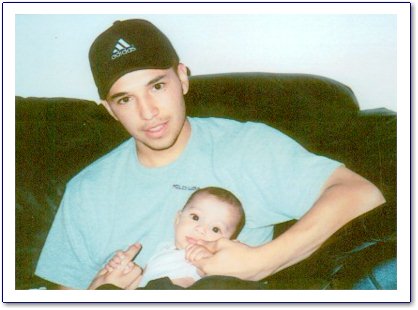 Isidro Jamil Ortiz with a friends baby.